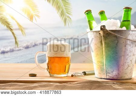 Beer Mug And Ice Bucket Filled With Beer Bottles On Wooden Base And Beach Background With Palm Tree