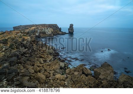 Long Exposure Seascape Of The Cliffs Of Papoa Island In Carvoeiro Cape From The Sea At Sunrise In A 