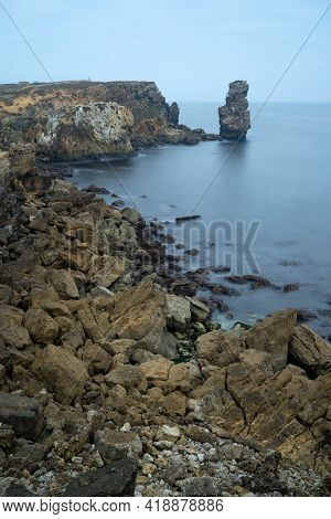 Long Exposure Seascape Of The Cliffs Of Papoa Island In Carvoeiro Cape From The Sea At Sunrise In A 
