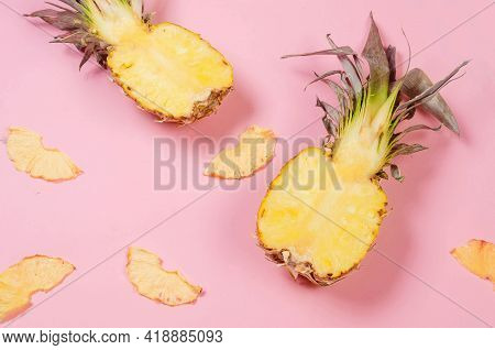 Ripe Juicy Pineapple On Pink Background And Dried Pineapple Wedges Around. Fruit Chips. Healthy Eati