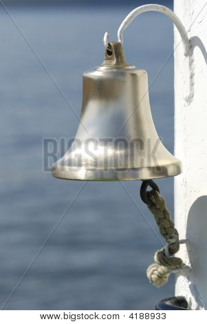 Ship Metal Bell With Rope On A White Hook