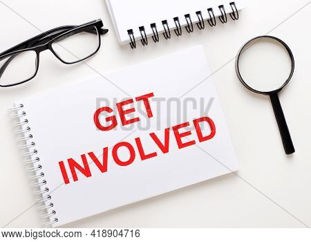 Get Involved Is Written In A White Notebook On A Light Background Near The Notebook, Black-framed Gl