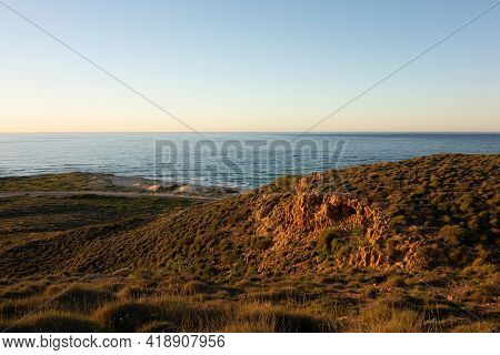 Landscape Of Coastline And Rocks Near Coastline And Vlamingh Head Precinct Lighthouse During Sunset