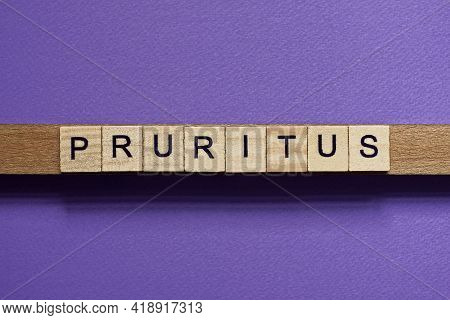 Brown Word Pruritus In Small Square Wooden Letters With Black Font On A Lilac Background