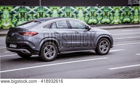 Moscow, Russia - April 2021: Side View Rolling Shot With Gray Car In Motion. Mercedes Gle Class Driv