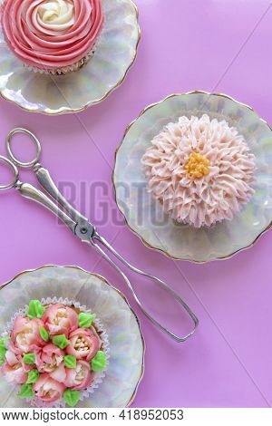 Colorful Cup Cakes Decorated With Icing On A Pink Background Ideal For A Cooking , Teaching Poster O