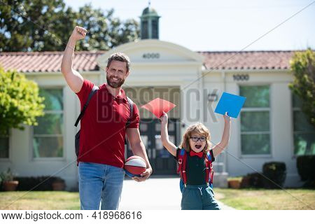 Excited Father Walking Son To School. Amazed Parent And Pupil Of Primary School Schoolboy With Backp