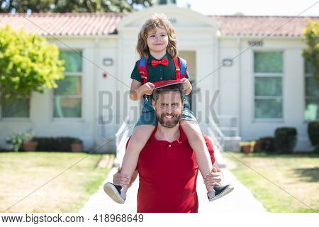 Father Get A Son Pupil Piggyback Ride After Study School. Family, Education And Outdoor Concept.