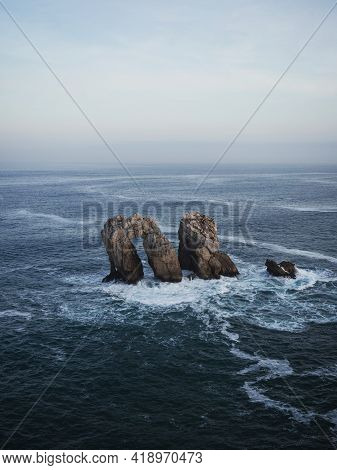 Panorama View Of Urro Del Manzano Rock Formation Sea Stack Natural Arch Bridge In Liencres Arnia Cos