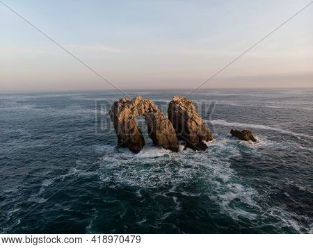 Panorama View Of Urro Del Manzano Rock Formation Sea Stack Natural Arch Bridge In Liencres Arnia Cos