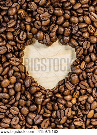 Roasted Brown Coffee Beans With Empty Heart Form Shape.