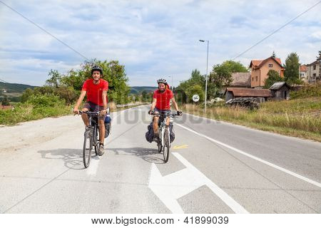 MOSTAR, BOSNIA - AUGUST 14: Young cyclist touring from Madrid to Istanbul on August 14, 2012 near Mostar, Bosnia. A growing number of eco-travellers tour by bike to lessen their carbon footprint.