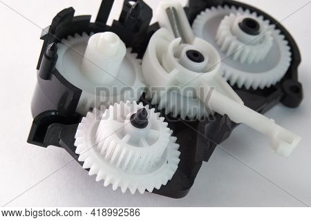 White Plastic Spur Gears Connected In Complex Mechanism, Part Of The Inkjet Printer Paper Feeder Mec