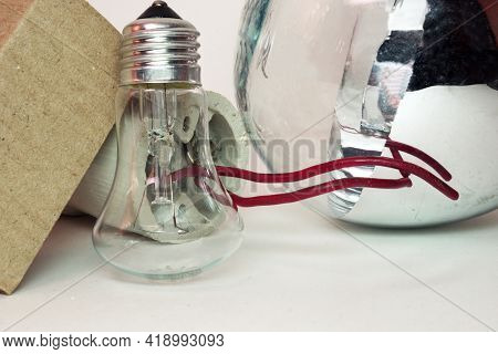Huge Outdated High-power Incandescent Bulb And Ceramic Lamp-holder Of Street Light Lamp Near The Sta