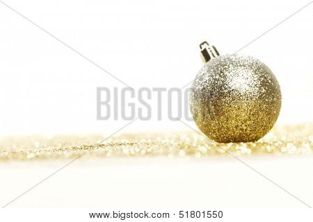 Silver christmas ball on shiny golden background