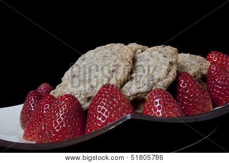 strawberries and cookies on a plate