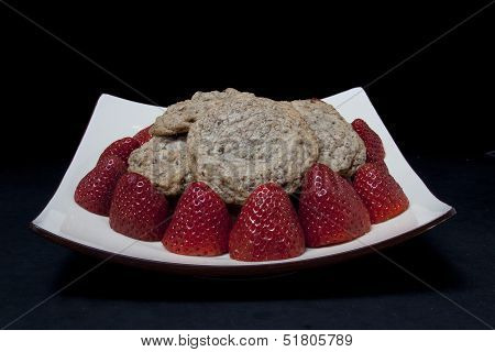 strawberries and cookies on a plate