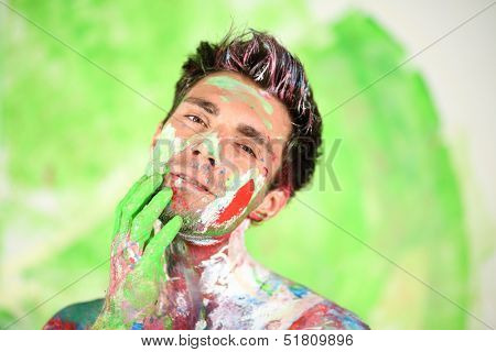 Whole painted young man with hand near face bowed his head