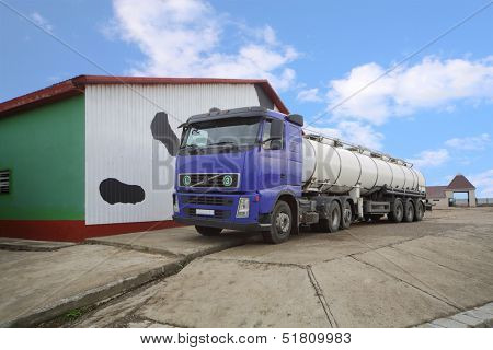 Truck for the production of milk loading stand near a barn 