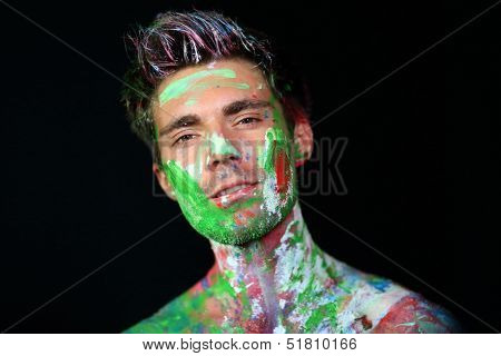 Portrait of a man covered in paint in the studio