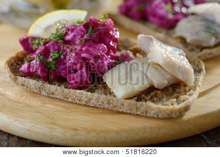 Sandwiches with herring and salad