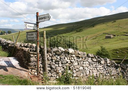 Rusty sign post pointing to places in the Yorkshire Dales