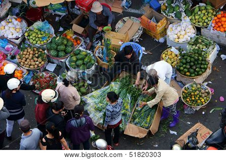 People buy and sell fruit at open air market