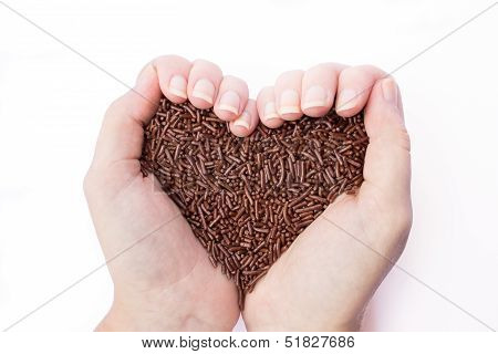 Two hands holding chocolate sprinkles