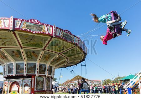 Nieuwehorne, The Netherlands - Sep 28: Fair With Unknown Children At A Wooden Carousel During The Ag