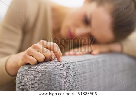 Closeup On Hand Of Frustrated Young Housewife Sitting On Couch