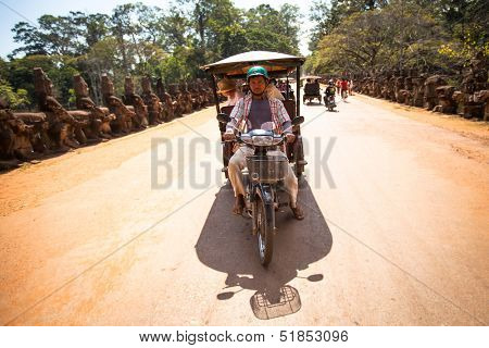 SIEM REAP, CAMBODIA - DEC 13: Unidentified cambodian moto-rickshaw in Angkor Wat, Dec 13, 2012 on Siem Reap, Cambodia. Angkor is the country's prime attraction for visitors.