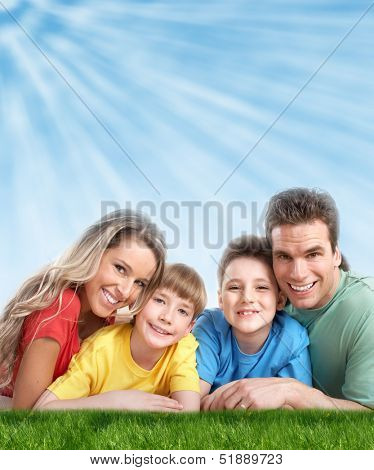 Happy family with two kids relaxing in park.