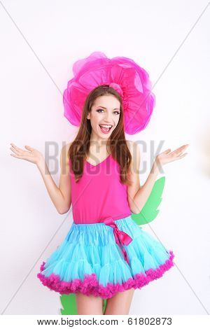 Beautiful young woman in petty skirt with big flower close up