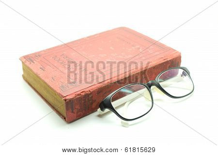 Old Book And Glasses Isolated On White