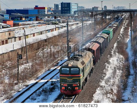 Goods Train Carries Cargo On Railway Track.