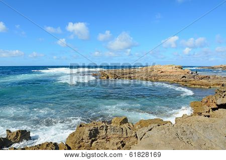 Yellow Rocks And Waves