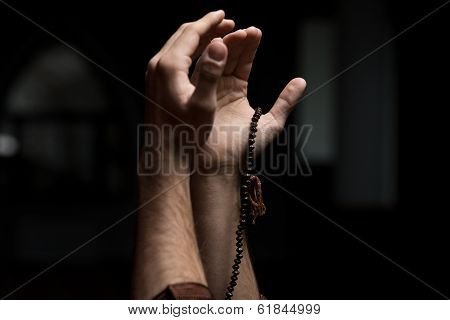 Hands Holding A Muslim Rosary