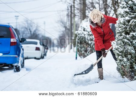 Woman Shoveling Her Parking Lot