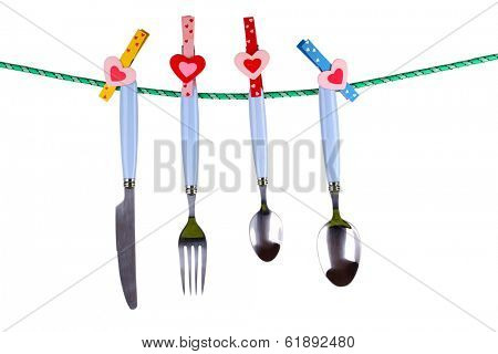 Cutlery dried on rope isolated on white