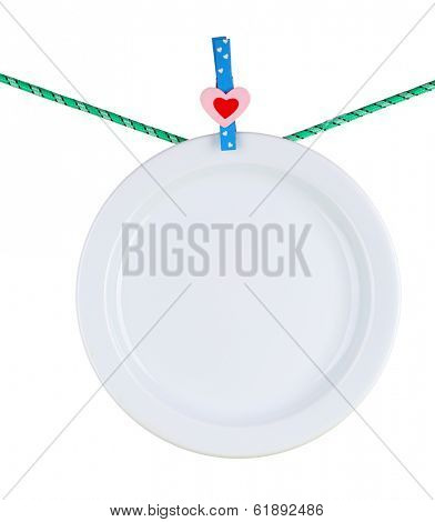 Plate dried on rope isolated on white