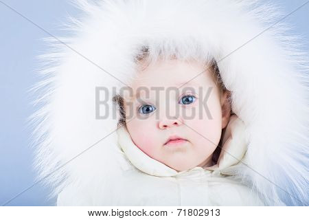 Sweet Baby In A White Snow Suit With A Fur Hood Looking Tired