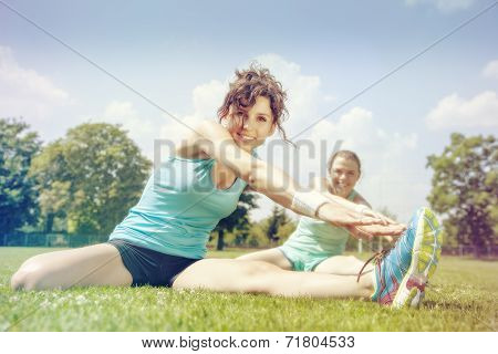 Two Young Girls Stetching Before A Jogging