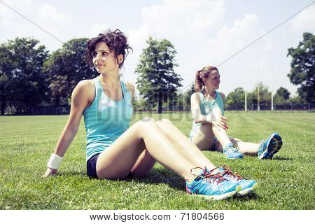 Two Young Girls Stetching Before A Jogging