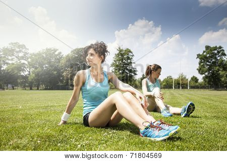 Two Young Girls Stetching Before A Jogging