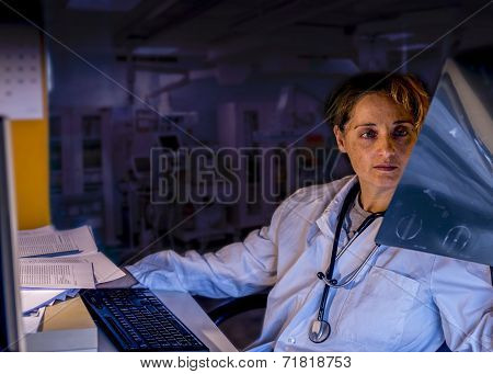 Tired Doctor Looking X Ray  At Night Duty
