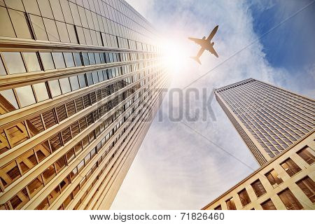 plane flying over office buildings in Frankfurt am Main, Germany