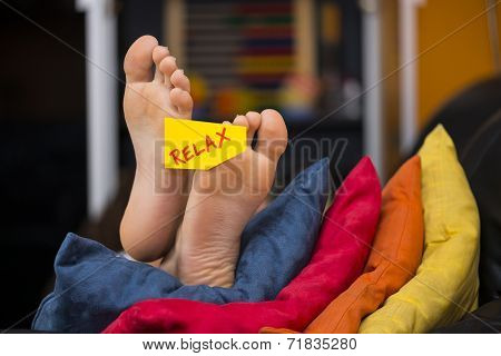 Feet On The Sofa With A Post Card And Relax