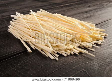 rennet cheese spaghetti snack on wooden table surface 