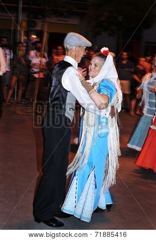 MADRID, SPAIN - AUGUST 10: People dancing the chotis on August 10, 2014 in Madrid, Spain. Chulapos and Manolas (men and women dressed in the traditional way) dance this popular dance of Madrid