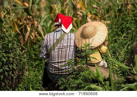 Red Dao Mother and Child resting in field